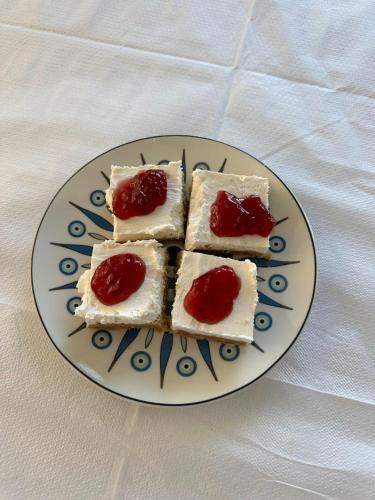 a plate with four pieces of food on a table at Anna Studios in Agios Prokopios