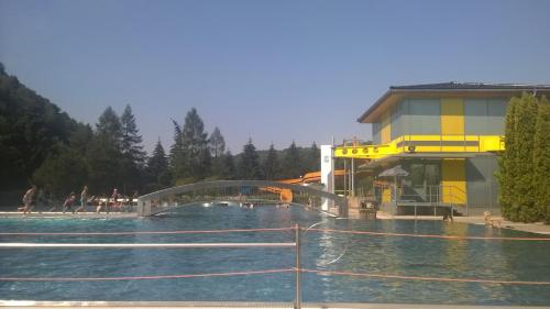 a swimming pool with a water slide in front of a building at Ferienwohnungen Langer in Stadt Wehlen