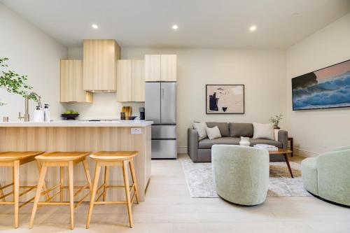 a kitchen and living room with a couch and a table at Casa De La Vina - Boutique Apartments in Downtown Santa Barbara in Santa Barbara