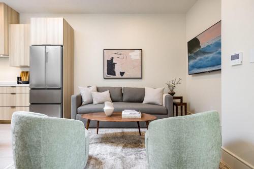a living room with a couch and a table at Casa De La Vina - Boutique Apartments in Downtown Santa Barbara in Santa Barbara