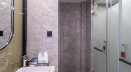 a bathroom with a shower and a sink and a toilet at Xiamen Seashine Lakeview Hotel in Xiamen