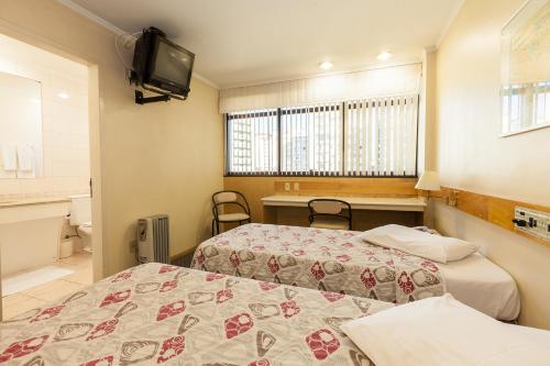 Tri Hotel Smart Caxiasにあるベッド