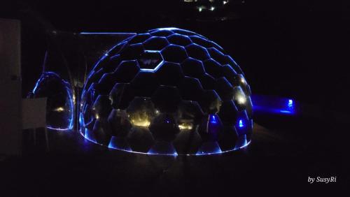 a glass ball with blue lights on a table at Palmaria Sky Bubbles Room in Ponza
