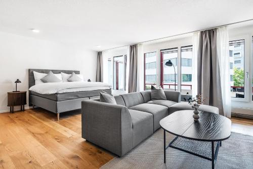 a living room with a couch and a bed at CITY-LOFT 1!Gratis parken, Free parking! in Schaffhausen
