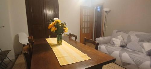 a wooden table with a vase of flowers on it at Casa Fulvia in Cannobio
