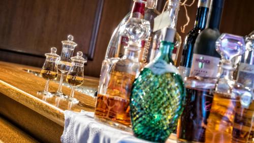 a group of bottles of alcohol on a table at Hotel Armin in Selva di Val Gardena