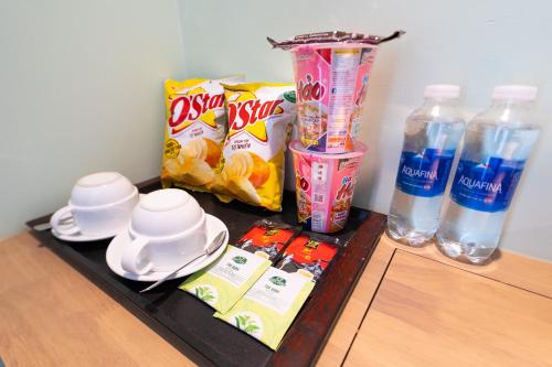 a tray with snacks and water bottles on a table at Nicecy Hotel - Trương Quyền in Ho Chi Minh City