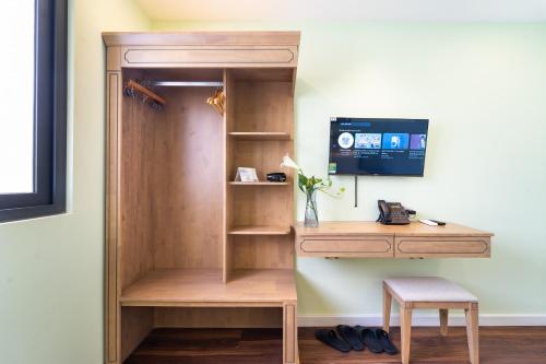 a desk with a computer in a room at Nicecy Hotel - Trương Quyền in Ho Chi Minh City