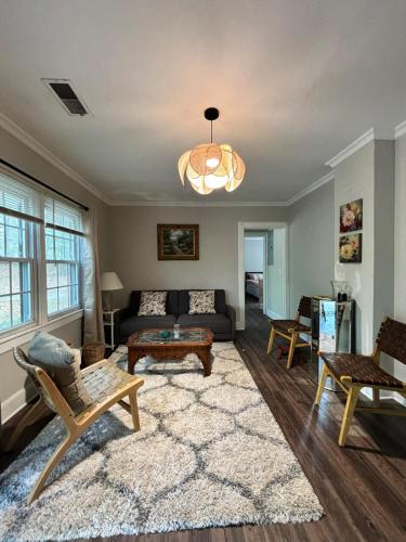 a living room with a couch and a table at Pine Haven Getaway -Crib, Pets Welcome, Perfect for Families & Groups in Birmingham