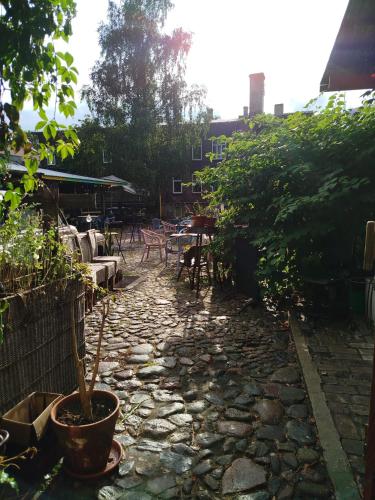 a patio with a potted plant and a table and chairs at Gypsy Camp Apartments & Glamping in Liepāja