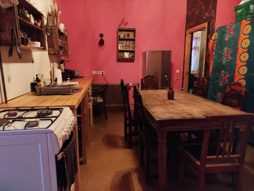 a kitchen with a stove and a table and a stove top oven at Gypsy Camp Apartments & Glamping in Liepāja