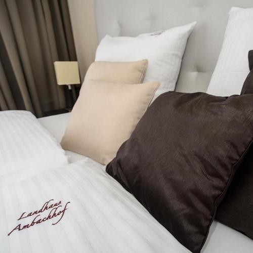 two beds with white and brown pillows in a room at Landhaus Ambachhof in Oetz
