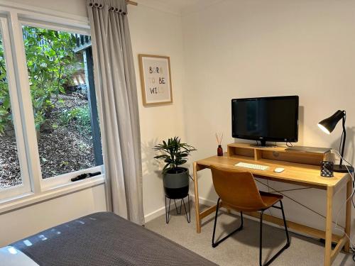 a bedroom with a desk with a computer and a window at Mt Martha - Mar Vista - Panorama views with Modern coastal style in Mount Martha