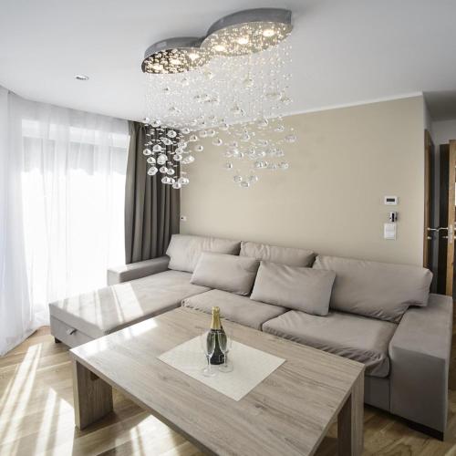 a living room with a couch and a table at Landhaus Ambachhof in Oetz