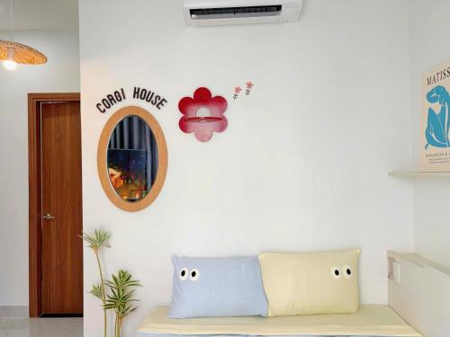 a living room with a couch and a mirror at Corgi House Central Nha Trang in Nha Trang