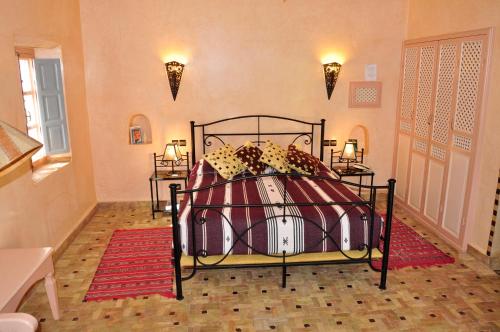 a bedroom with a bed in a room with lights at Hotel Dar Zitoune Taroudant in Taroudant