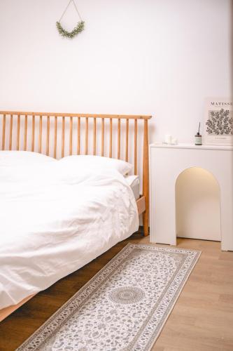 a bedroom with a white bed and a white table at Sillim Queen House in Seoul