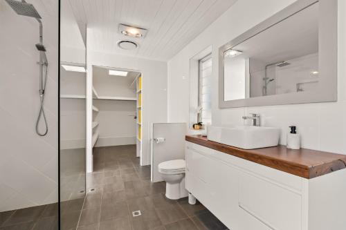 a bathroom with a sink and a toilet at Diamond Head Manor - Pool, Water Views, Central in Budgewoi