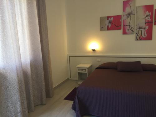 a small bedroom with a bed and a window at Albergo Ester in Piandimeleto
