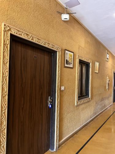 a wooden door in a room with a mirror at Hotel Royal Heritage in Jaisalmer
