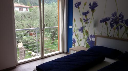 a bedroom with a bed and a window with a view at "CASABANA" - relax tutto l'anno - giardino - piscina Top in Malcesine