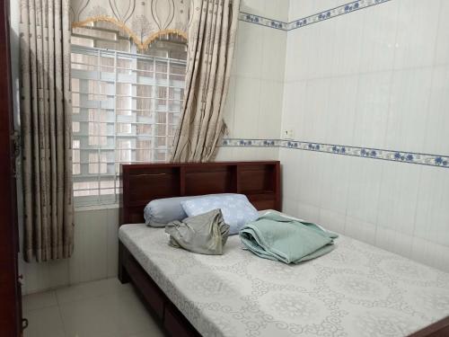 a bedroom with a bed with two bags on it at Hải Yến in Ba Ha
