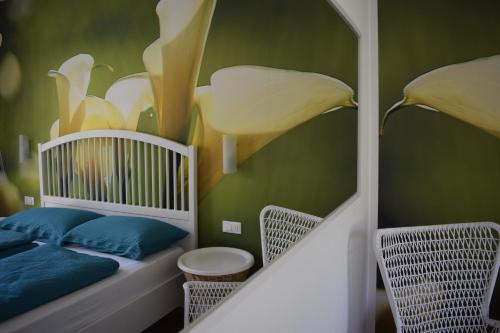 a nursery with green walls and a crib with blue pillows at "CASABANA" - relax tutto l'anno - giardino - piscina Top in Malcesine