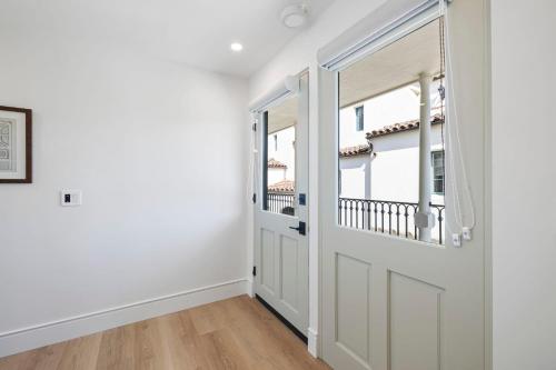 an empty room with a door and a window at Casa Jardin - Boutique Suites in Downtown Santa Barbara in Santa Barbara