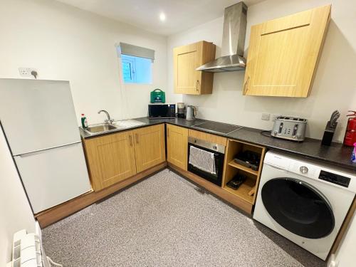 a kitchen with a white refrigerator and a dishwasher at Taigh Mor in Elgin