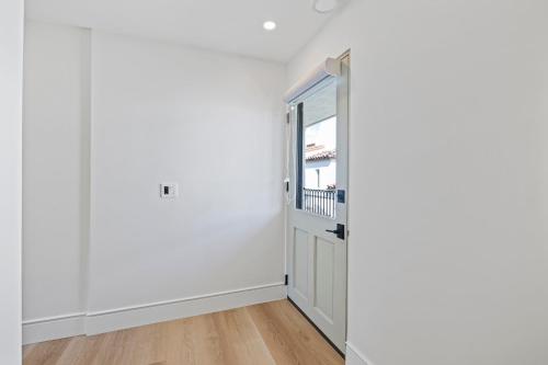 an empty room with a door and a window at Casa Jardin - Boutique Suites in Downtown Santa Barbara in Santa Barbara