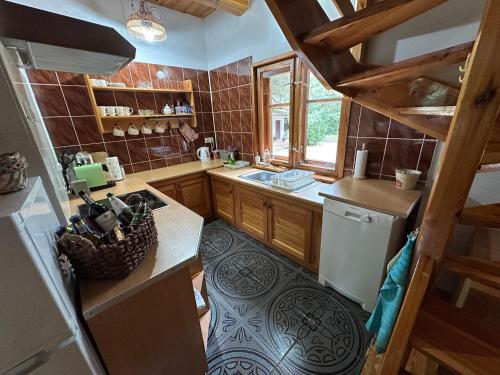 a small kitchen with a sink and a dishwasher at U źródła. Noclegi w Małym Dólsku in Mały Dólsk