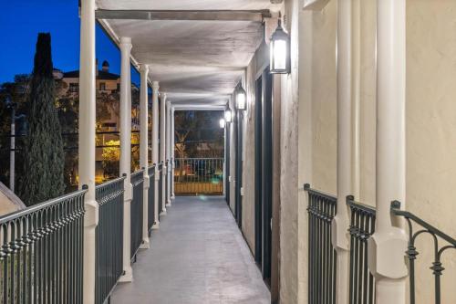 a hallway of a building with columns and lights at Casa Jardin - Boutique Suites in Downtown Santa Barbara in Santa Barbara