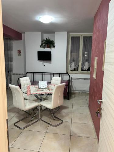 a dining room with a table and chairs and a television at B&B Le Tre Gemme Junior in Lentini