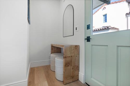 a white room with a table and a window at Casa Jardin - Boutique Suites in Downtown Santa Barbara in Santa Barbara