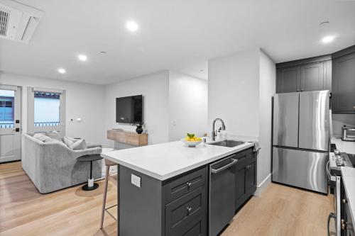 a kitchen with a sink and a refrigerator at Casa Jardin - Boutique Suites in Downtown Santa Barbara in Santa Barbara