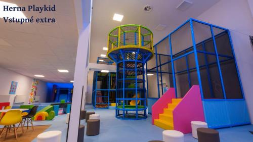 a room with a play area with colorful furniture at Hotel Frymburk in Frymburk