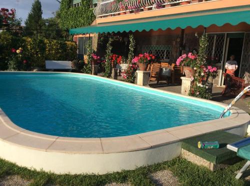 a swimming pool in front of a house at Villa Nanda a 15 minuti da Roma piscina esclusiva , villa nella natura in Formello