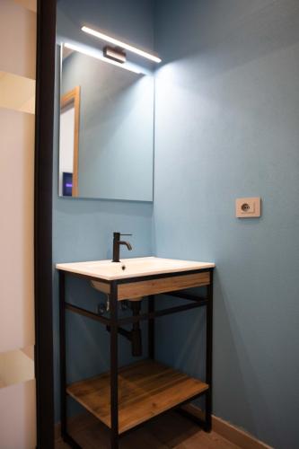 a bathroom with a sink and a mirror at Mhometredici Guest House in Sestu