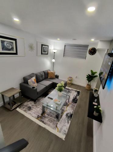 a living room with a couch and a table at ArbyManie's Place Newly Built Apartment in London