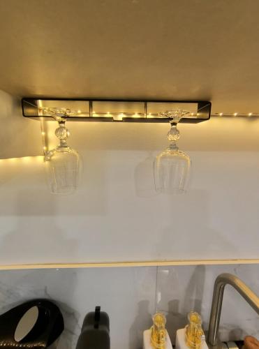 two glass lights on a shelf above a sink at ArbyManie's Place Newly Built Apartment in London