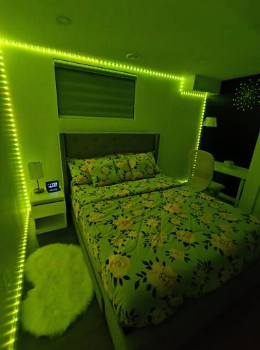 a bedroom with a bed with lights on it at ArbyManie's Place Newly Built Apartment in London
