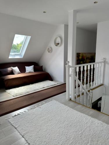 a bedroom with a bed and a staircase with a rug at Villa Viktória in Lunca de Sus