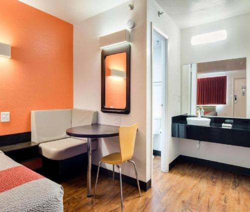 a room with a bed and a table and a bathroom at Hotel Royal Infinity Near Delhi Airport in New Delhi