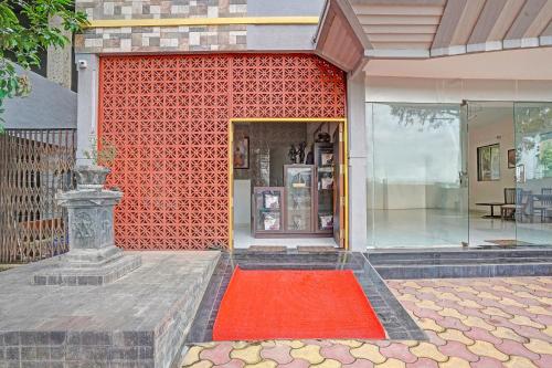 a red carpet in front of a red wall at FabExpress Kaveri Executive - Nr Alandi vithoba temple in Pune