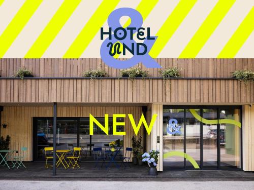 a hotel and new sign on the front of a building at Hotel UND - smart alpine stay in Schladming