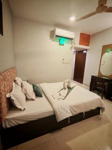 a bed in a room with a green light at Sylhet Paradise Inn in Sylhet