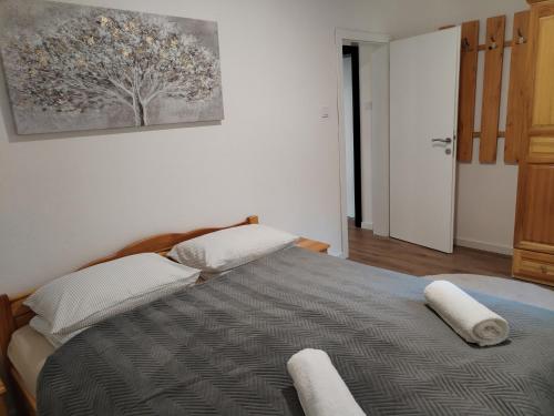 a bedroom with a bed with two pillows on it at Friends 2 Vlašić in Vlasic