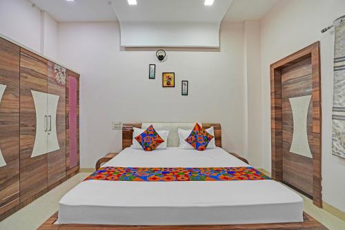 a bedroom with a bed in a room at FabExpress Kaveri Executive - Nr Alandi vithoba temple in Pune