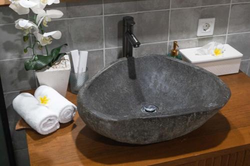 a sink in a bathroom with a sink at Ubud Suarga Private Pool Villa in Ubud