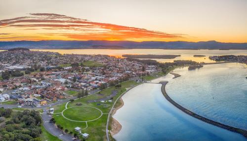 an aerial view of a town next to the water at Seabreeze on the Beach in Barrack Point
